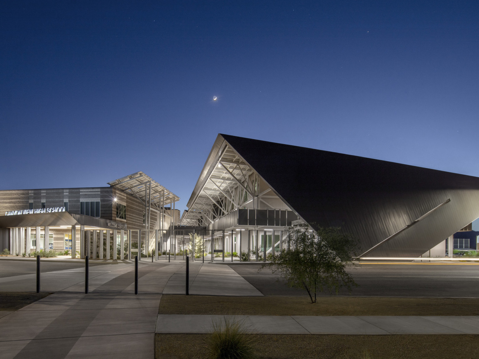 Canyon View High School campus is a modern steel building with exposed structural beams and solar canopies
